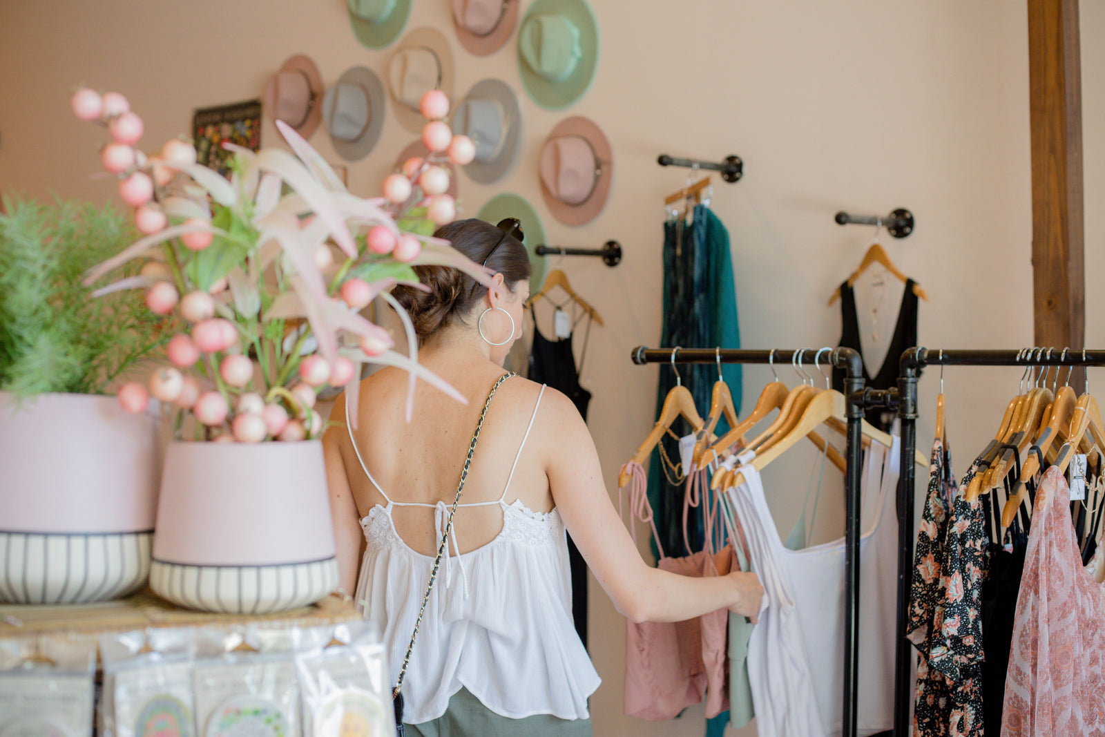 Person browsing clothes on a rail in a clothing store